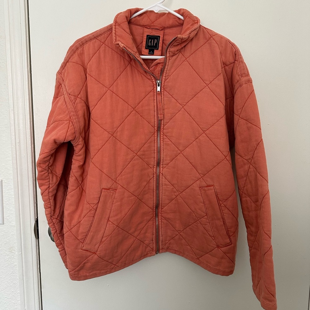 Woman’s orange quilted jacket from the Gap